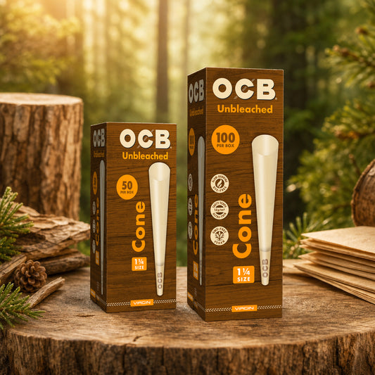 Two OCB Unbleached cone packaging boxes, one 50-count and one 100-count, displayed on a rustic tree stump in a forest setting.